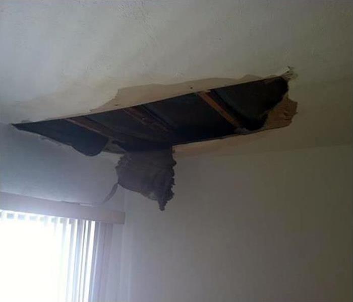 water on a ceiling leads to damage, whole on a ceiling